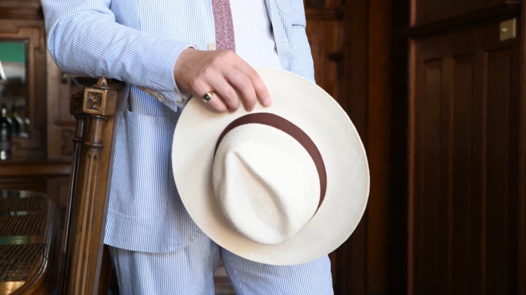 Raphael holding his Panama fedora indoors